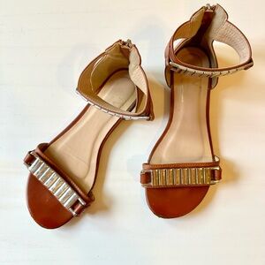 Versace Leona Brown Leather Ankle-Strap Sandals with silver-Tone Embellishments.